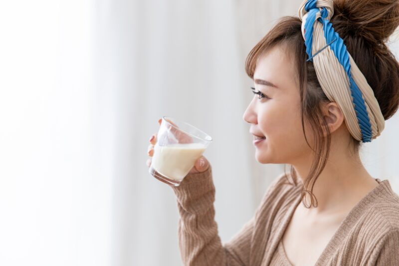 a woman drinking soymilk